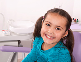 Young girl smiling in dental chair