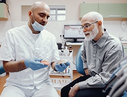 Older man smiling after learning how dentures are made in Castle Rock