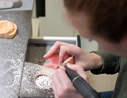 Lab technician creating dentures