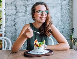 Young woman smiling while wearing dentures